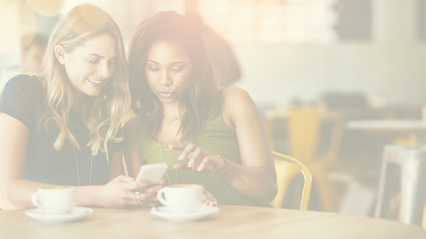 Two young women with a mobile phone