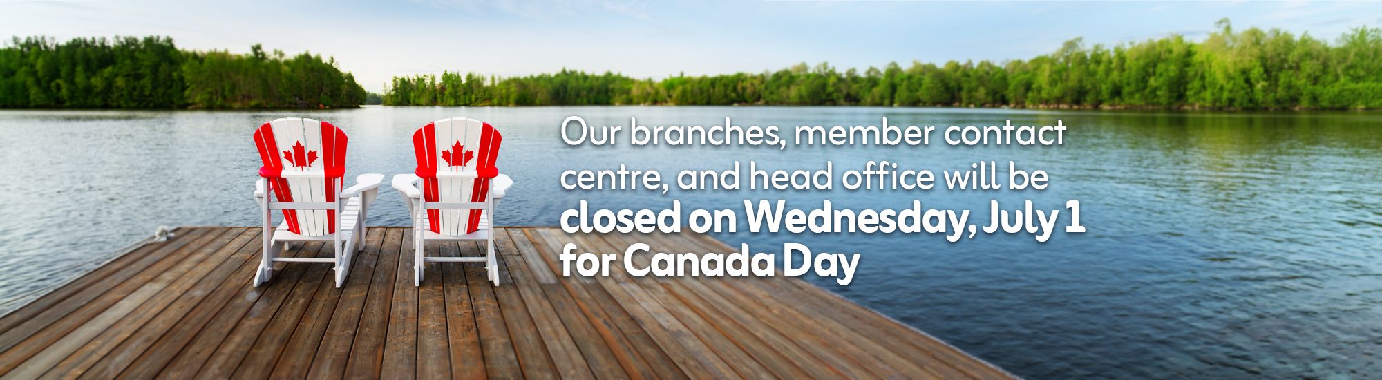 Muskoka chairs on a dock with Canadian Flags.