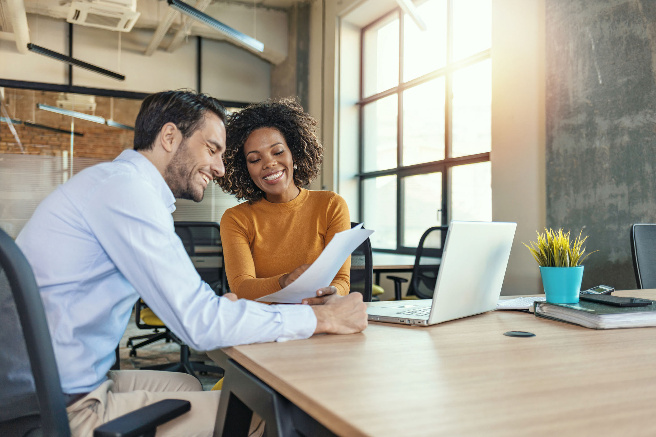 A man and woman discussing finances at a table